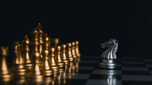 istock Silver king winner surrounded with silver chess pieces on chess board game competition.concept strategy, leadership and success business. 1327411401