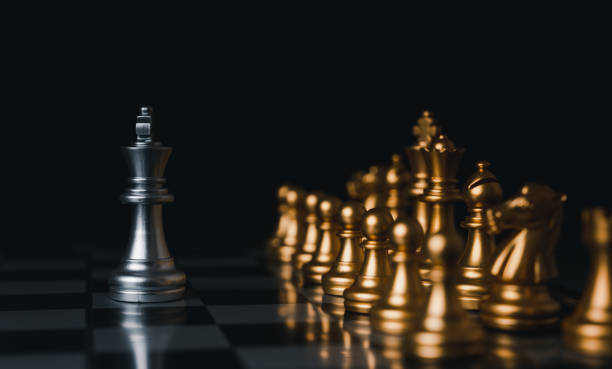 istock Silver king winner surrounded with silver chess pieces on chess board game competition.concept strategy, leadership and success business. 1327411469