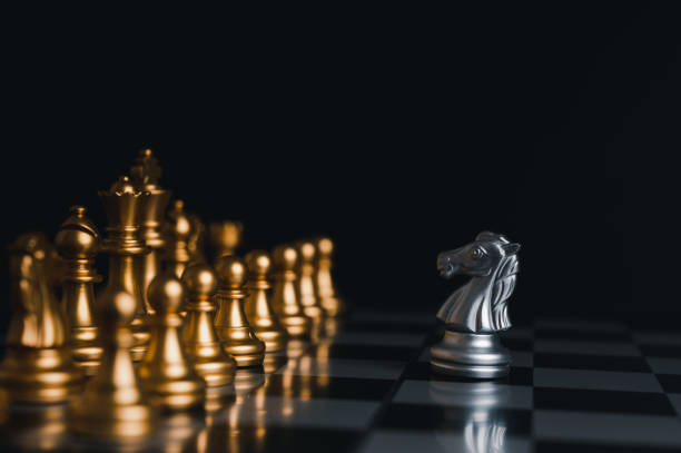 istock Silver king winner surrounded with silver chess pieces on chess board game competition.concept strategy, leadership and success business. 1327411497
