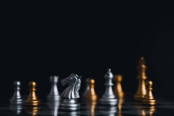 istock Gold king winner surrounded with silver chess pieces on chess board game competition.concept strategy, leadership and success business. 1327412085