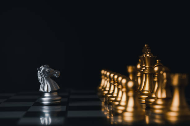 istock Silver king winner surrounded with silver chess pieces on chess board game competition.concept strategy, leadership and success business. 1327412098