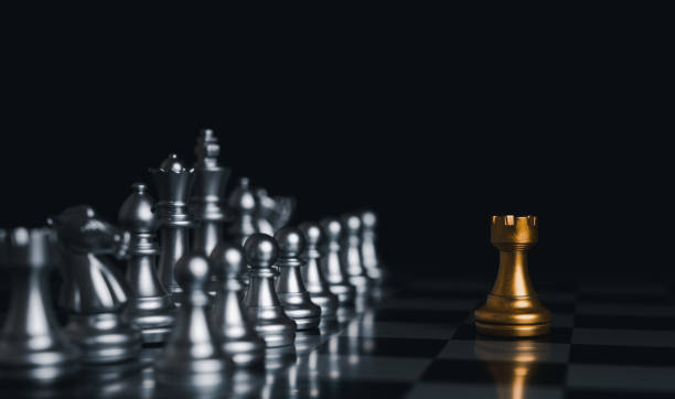 istock Gold king winner surrounded with silver chess pieces on chess board game competition.concept strategy, leadership and success business. 1327412283
