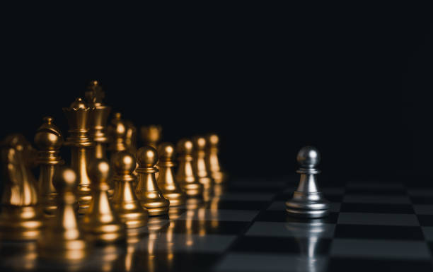 istock Silver king winner surrounded with silver chess pieces on chess board game competition.concept strategy, leadership and success business. 1327412318