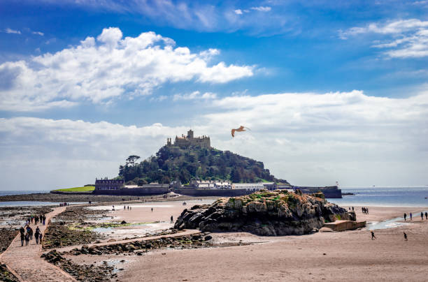 St Michael's Mount, UK - April 19 2014: View of the island with the castle on the hill. St Michael's Mount is a tidal island in Mount's Bay, Cornwall, accessible by foot on low tide