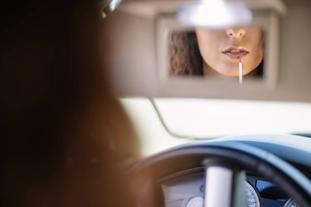 istock Woman fixing her makeup in the car 1327413838