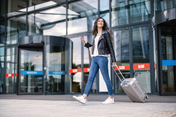 Woman coming out from the airport stock photo