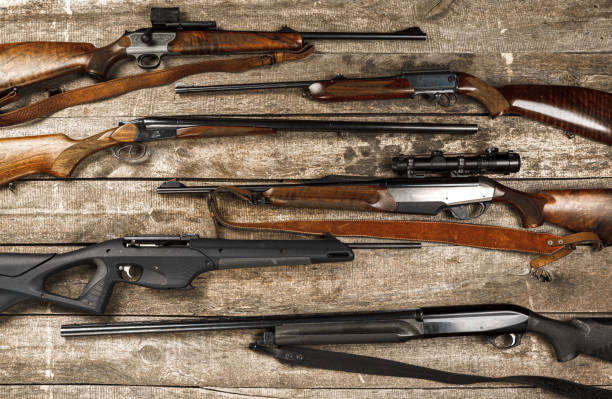istock Many hunting rifles on weathered wooden surface 1327413887