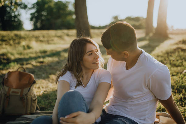 istock Lovely couple in meadow enjoy the sunset 1327413921