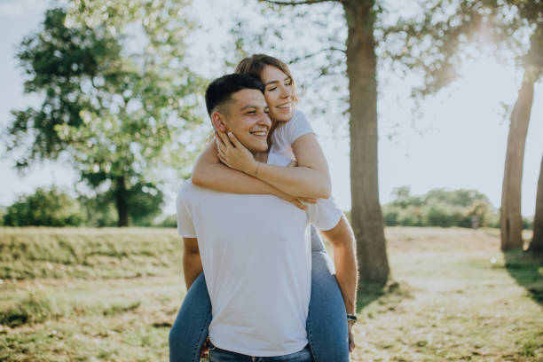 istock Lovely couple in meadow enjoy the sunset 1327414049