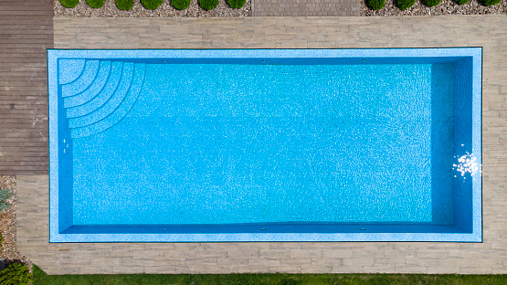 Aerial. Modern luxury pool with staircase. Top view from drone.