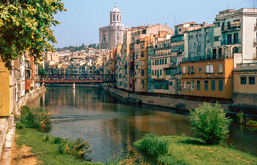 Pastel-coloured houses that line the bank of the river in the old city district. Pont de Ferro, an iron bridge built by Gustave Eiffel, offers beautiful views of the city. Cathedral in the background