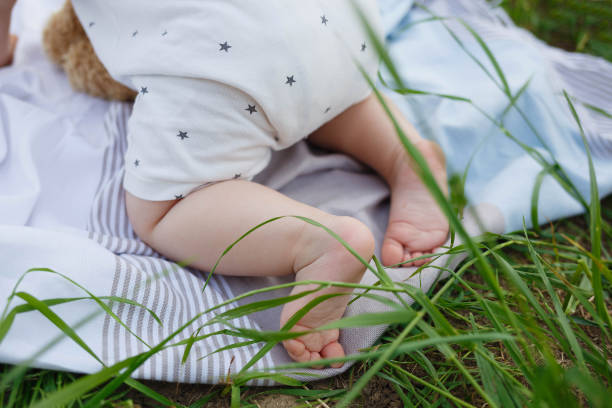 istock filming close-up: small bare feet of children 1327417333