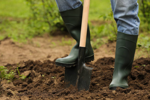 istock Worker digging soil with shovel outdoors, closeup. Gardening tool 1327419807