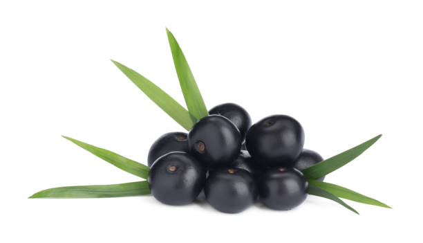 Pile of fresh ripe acai berries and green leaves on white background Pile of fresh ripe acai berries and green leaves on white background acai stock pictures, royalty-free photos & images