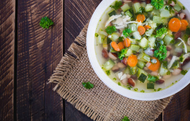 istock Chicken fillet vegetable soup in  bowl on wooden rustic table. Top view, flat lay 1327421901