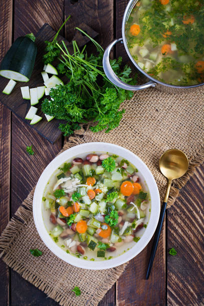 istock Chicken fillet vegetable soup in  bowl on wooden rustic table. Top view, flat lay 1327421913