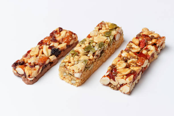 istock Three protein bars with cereals isolated on white background close-up. 1327422339