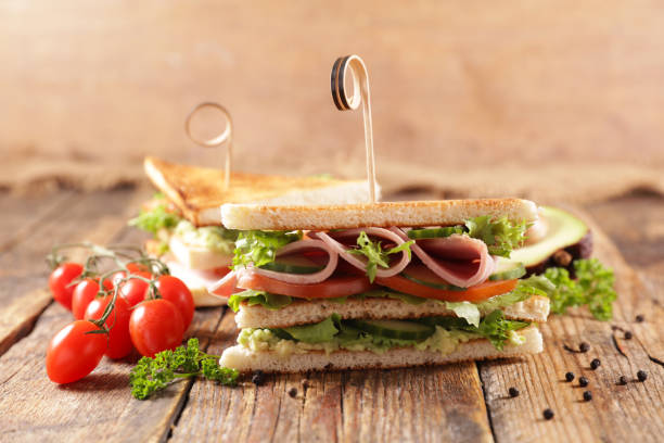 istock sliced club sandwich on wood background 1327422857