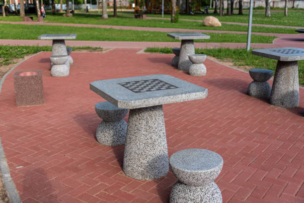 istock Stone tables with a painted chessboard in a city park. 1327423553