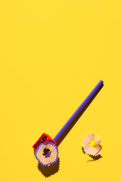 istock Pencil with shavings and pencil sharpener on yellow background. Colorful creative template. Back to school concept. 1327423716