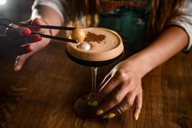view of glass of delicious drink which woman's hand decorated by small marshmallow balls view of glass of delicious cold frothy coffee drink which woman's hand decorated by small marshmallow balls garnish stock pictures, royalty-free photos & images