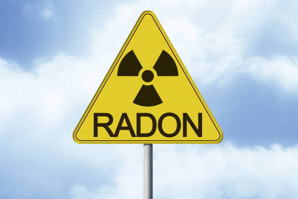 Danger Of Radioactive Contamination From Radon Gas Concept With Warning Symbol Of Radioactivity On Road Sign Image With Copy Space Stock Photo - Download Image Now - iStock