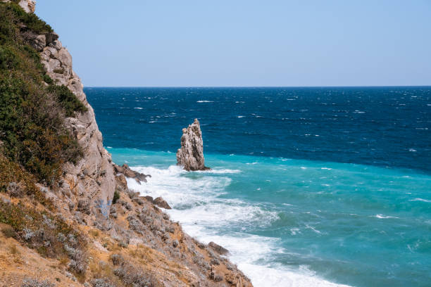 istock Rough sea with waves crashing against cliffs in Crimea 1327424960