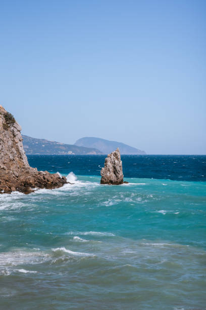 Rough sea with waves crashing against cliffs in Crimea, black sea, view from Yalta, swallow's nest
