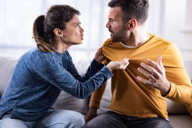 istock Mid adult couple arguing on sofa at home. 1327425778