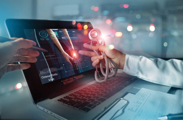 istock Medicine doctor team meeting and analysis. Diagnose checking osteoarthritis knee testing result with modern virtual interface on laptop, Joint ache problems, Medical technology network. 1327426563
