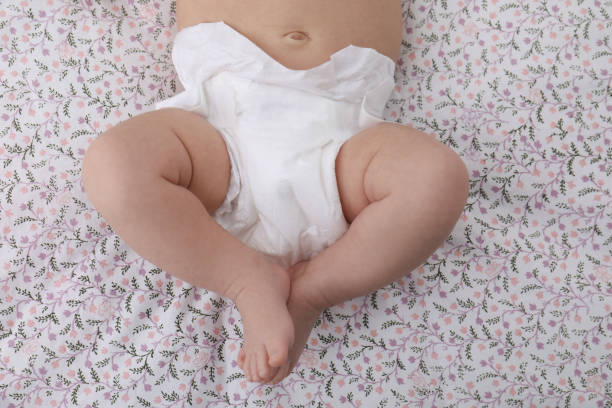 istock Little baby in diaper on bed, top view 1327426668