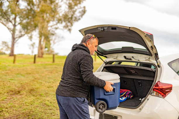 istock Middle aged man with his car and a cooler by a river 1327426842