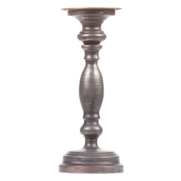 istock Old-fashioned black candlestick isolated on white background 1327429270