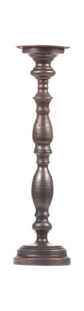 istock Old-fashioned black candlestick isolated on white background 1327429276