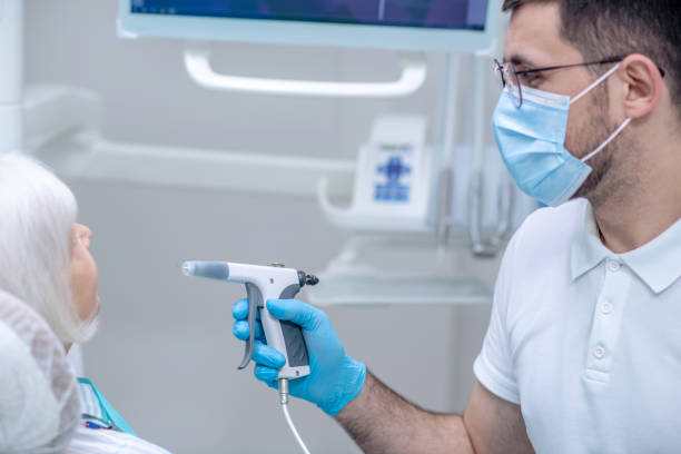 istock Dentist in sterile gloves working with a patient in his office 1327429819