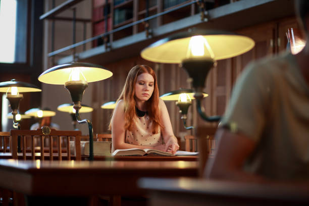 istock Young woman studying in library 1327429984