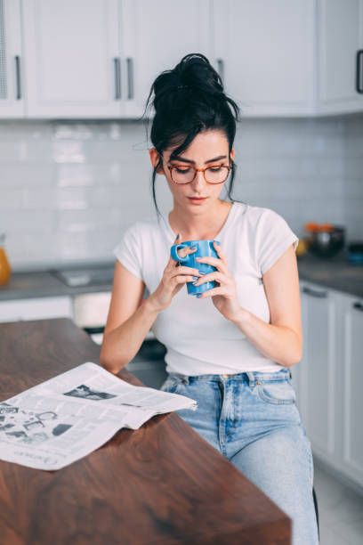 istock Beautiful young woman in kitchen 1327433251