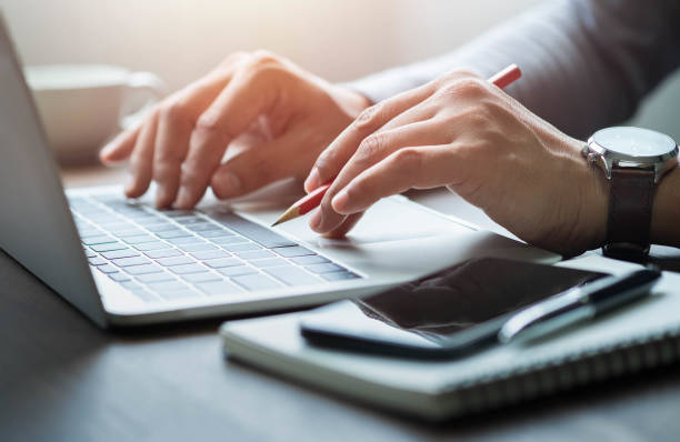 istock Close-up of man hands using and typing keyboard of laptop computer on office desk. Workspace, businessman working project creative idea for job online network. Business finance and technology concept. 1327433548