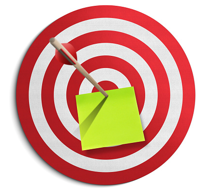 Red dartboard, adhesive note and arrow on white background