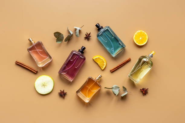 Set of perfume bottles with fragrance spaces and fruits stock photo
