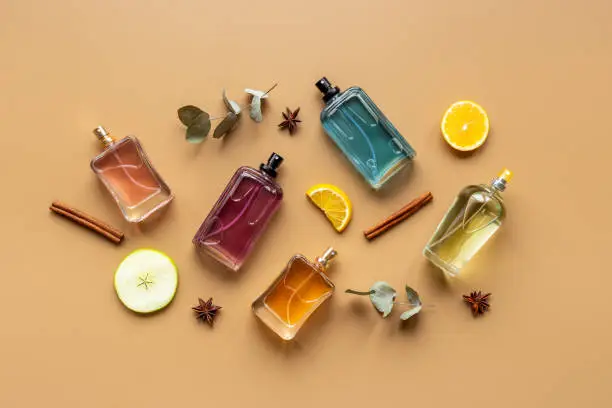 Photo of Set of perfume bottles with fragrance spaces and fruits