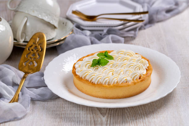 istock Classic Cheesecake with whipped cream on table 1327437237