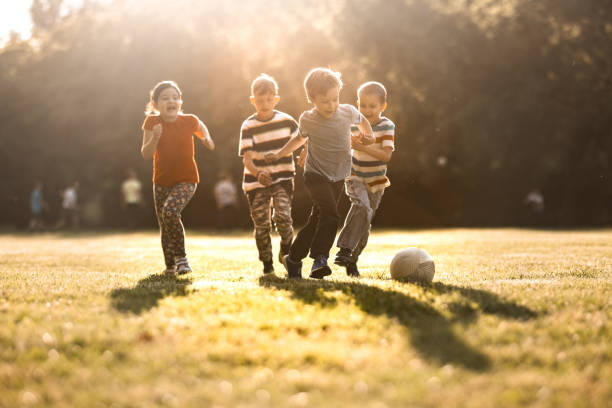 istock Children playing soccer on the meadow 1327439930
