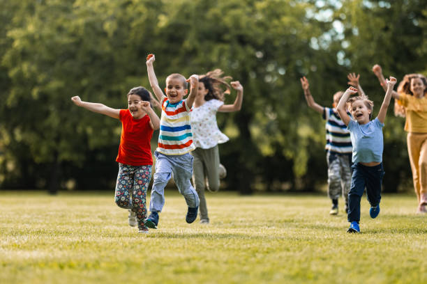 istock Happy children having fun while running on the meadow 1327440118
