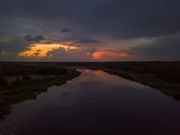 istock Beautiful, fascinating sunset with clouds over a lake, a river on a summer evening, view from a drone 1327442064