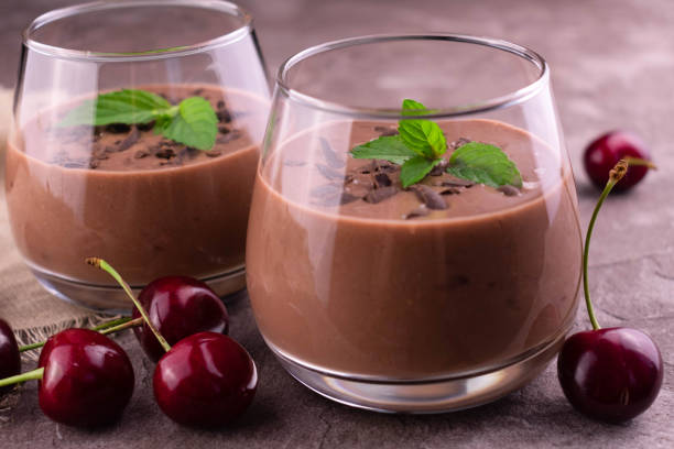 istock Chocolate cherry smoothie in a glass on a gray background. Close-up. 1327442286