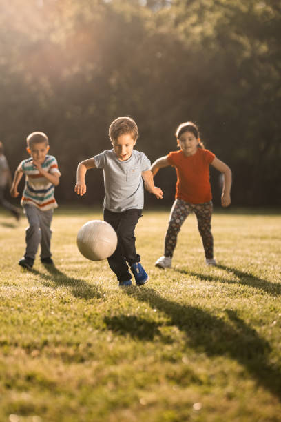 istock Children playing soccer 1327442429
