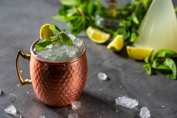 istock Moscow mule cocktail in copper cup with lime, ginger beer, vodka and mint garnish 1327446490