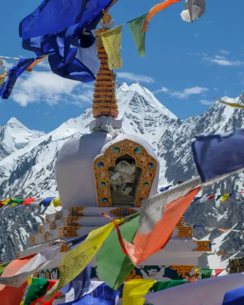 Dhar Thachakarpo, India - June 2021: A Buddhist stupa at the high pass of Kunzum La in Spiti valley with a background of Himalayan mountains on June 27, 2021 in Himachal Pradesh, India.