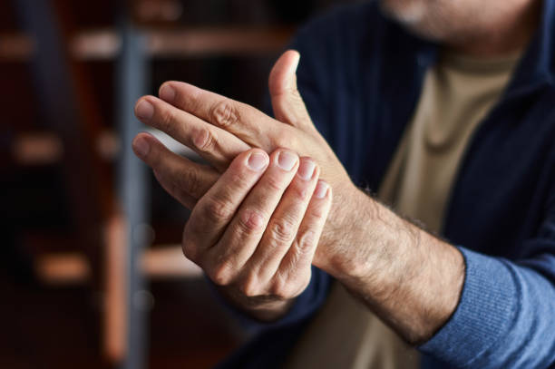 istock Hands of middle aged man with arthritis pain. 1327446773